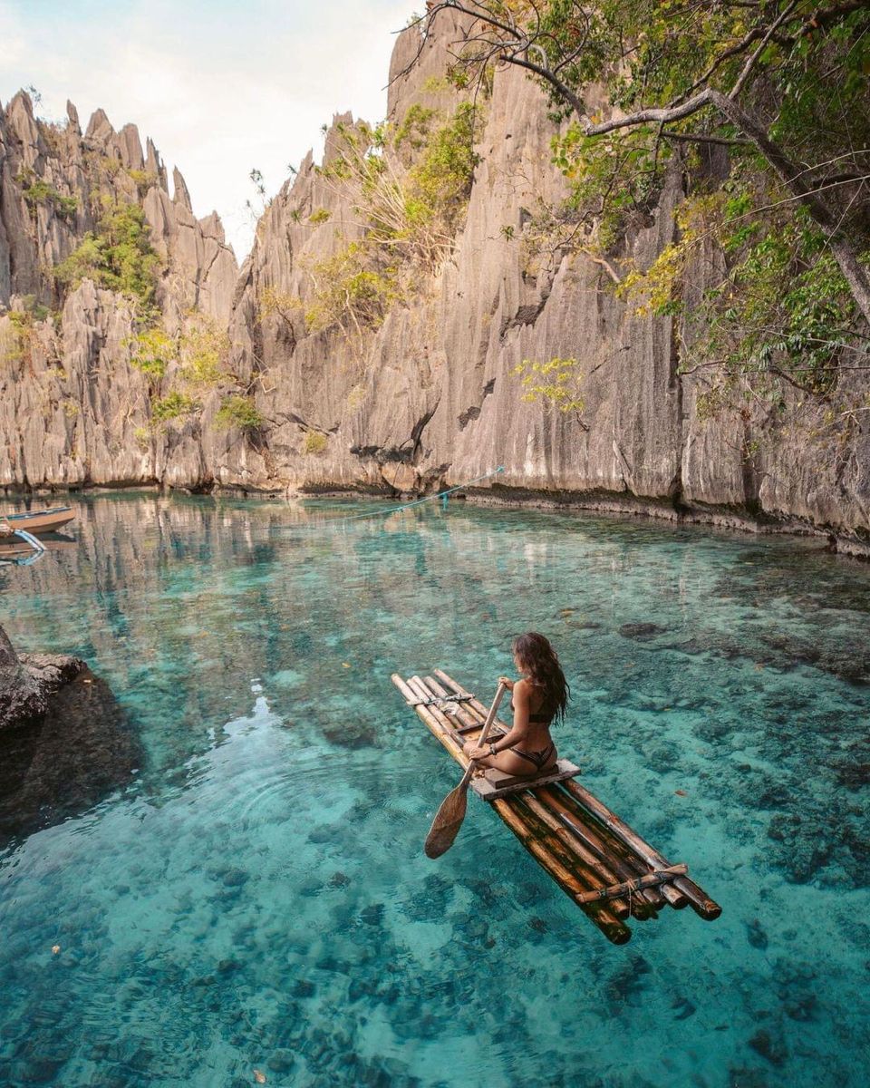 Turquoise lagoon surrounded by limestone cliffs in Coron